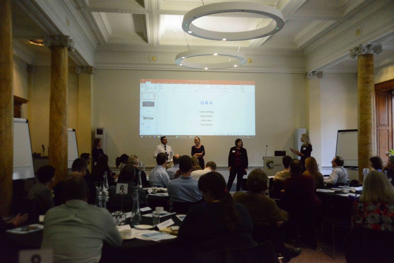 Person presenting to large room of people