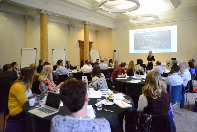 Person presenting to large room of people