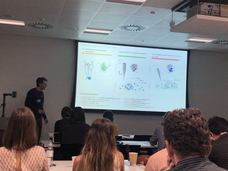 Group watching presentation at Mixing chemistry with medical research event